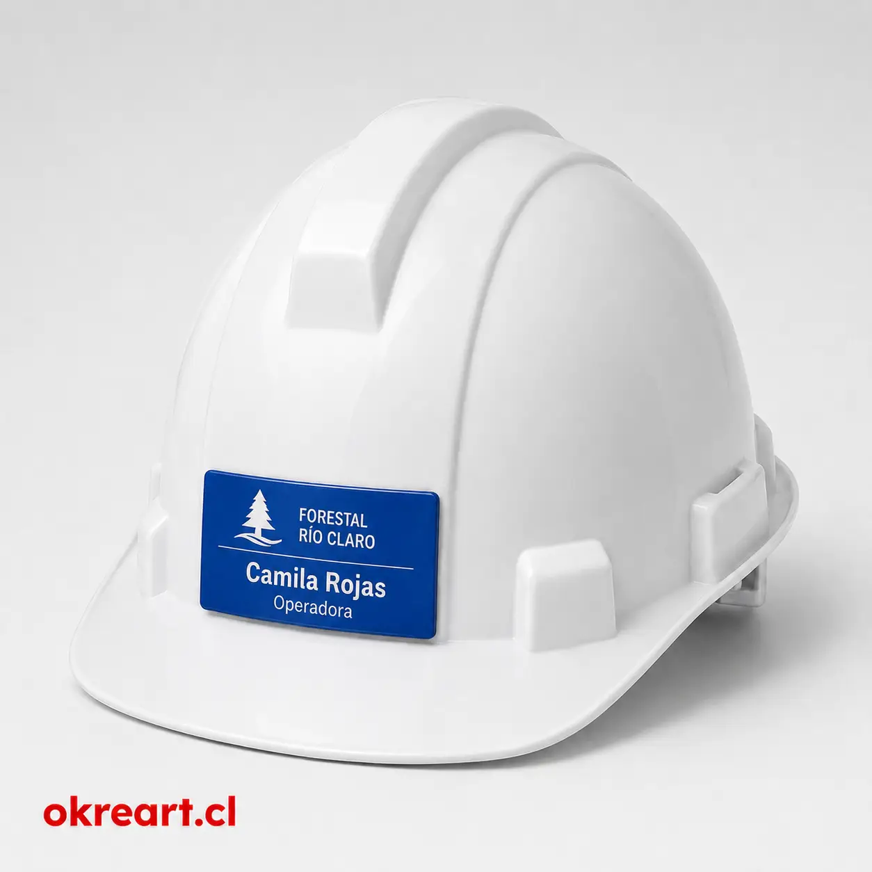 Placa azul para casco de seguridad de 6x3 cm en casco blanco, vista ladeada, personalizada con nombre y cargo.